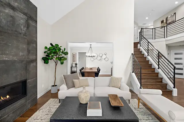 Cottage Lake whole-house remodel in Woodinville with a linear fireplace, open staircase with black railing and living room
