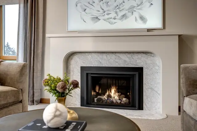 Living room at The Farm in Woodinville with a white marble fireplace surround and styled seating