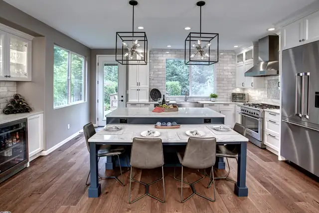Sammamish kitchen and family room remodel with a navy island table, cube pendants, white cabinets and stainless appliances
