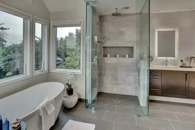 Sammamish primary bath remodel with a freestanding tub by the windows, glass shower and floating wood vanity
